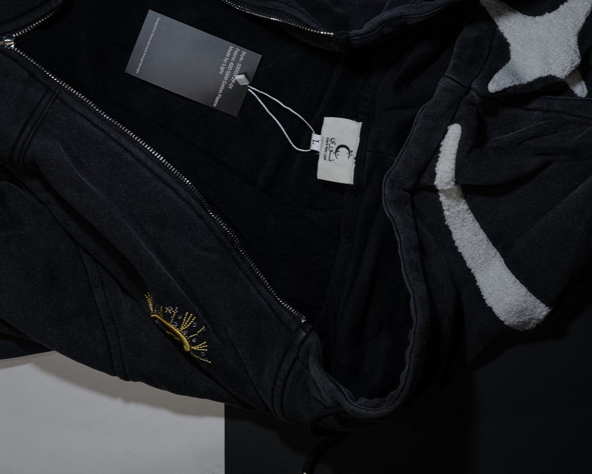 The Dawn zip-up opened to show the fleece lining, care label and gold crescent on the sleeve